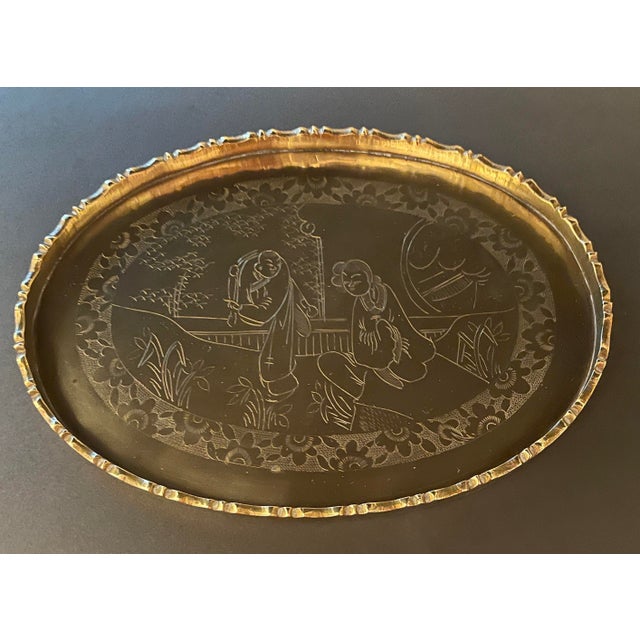 1960s Chinese figural brass tray, oval with a scalloped rim. Marked "MADE IN CHINA" on the back.