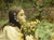 Wild Flowers by Nadezda | Oil on Panel Portrait of a girl holding a bouquet of wildflowers. For Sale