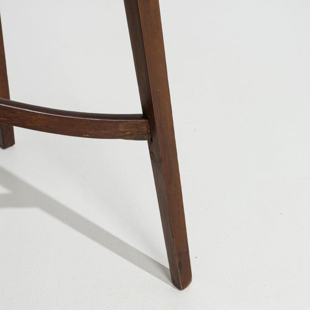 A 19th century English side table crafted in mahogany, featuring a narrow rectangular top and slender support legs. The...
