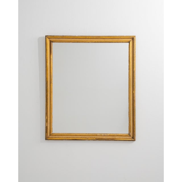 A 19th century French wall mirror crafted in giltwood, featuring a traditionally proportioned frame with understated...