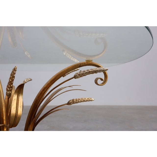 Evoking the glamour of mid‑century Parisian interiors, this gilt‑metal and glass coffee table embodies the timeless...