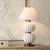 The Irena Table Lamp Features Stacked Ribbed Spheres Finished In A Glossy White Glaze, Accented With Heavily Antiqued...