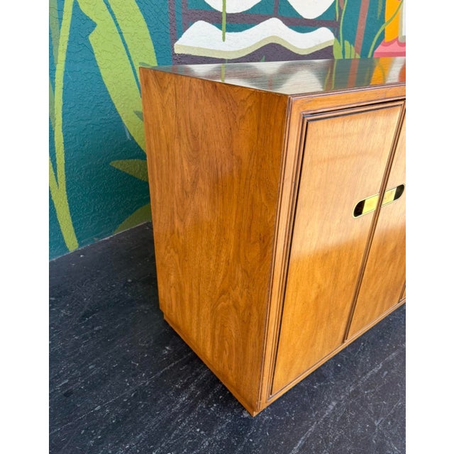 Hefty campaign Drexel Preface dresser that has ample storage with two sections of 4 drawers behind double doors and 4...