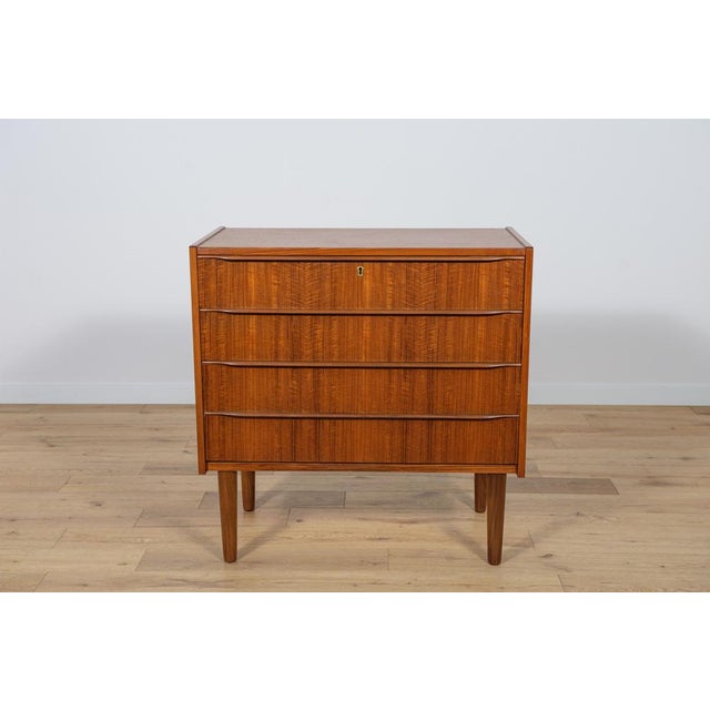 Mid-Century teak dresser made and manufactured during the 1960s in the Denmark. The dresser has profiled handles. The...