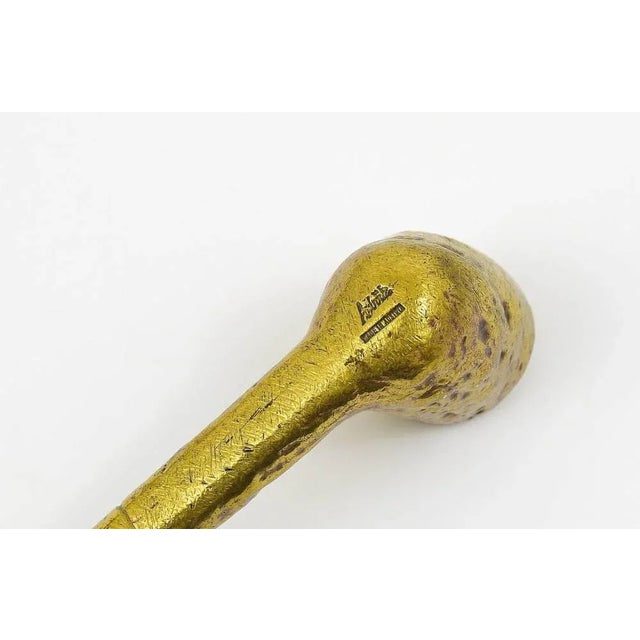 A rare Austrian brass paperweight, displaying a pipe, designed an executed in the 1950s by Carl Aubock, Vienna. A very...