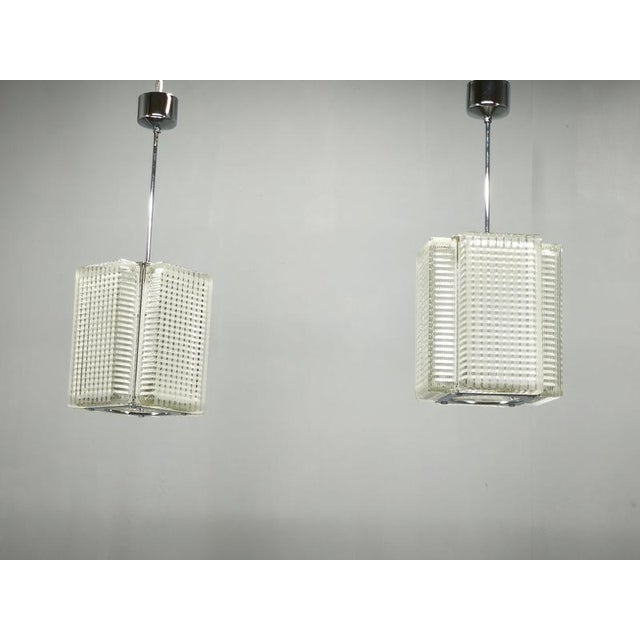 Sculptural pair of pendant lights by napako, produced in czechoslovakia during the 1970s. Each pendant features four...
