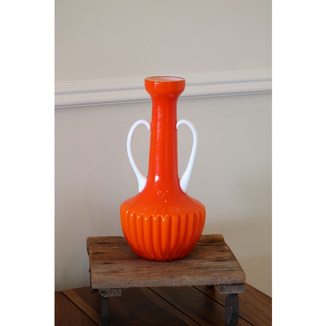 This is a stunning 2-handled vase, orange opaline glass cased over white. The simplicity of the glass and absence of...
