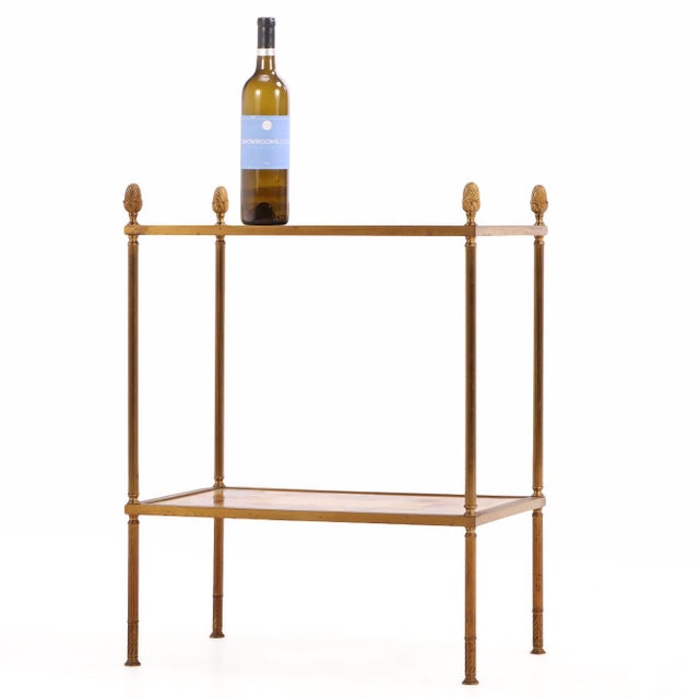 An elegant French brass two-tier occasional table featuring shelves composed of dried flowers artistically preserved...