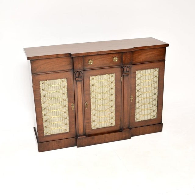 A stunning antique Regency period mahogany grill front sideboard. This was made in England, it dates from around the...