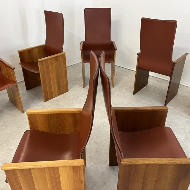 Set of 8 "Torcello" dining chairs by Afra and Tobia Scarpa for Stildomus, in walnut and leather, 1960s. This elegant set...