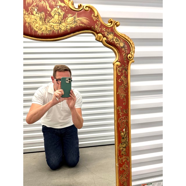 Visually rich Italian carved wood mirror with burgundy and gold Chinoiserie decoration, c. 1960s. Measures 31" W x 46" H.