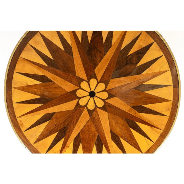 A 19th Century French Specimen Wood Centre Table. Of circular form, this table has a beautiful parquetry top banded with...