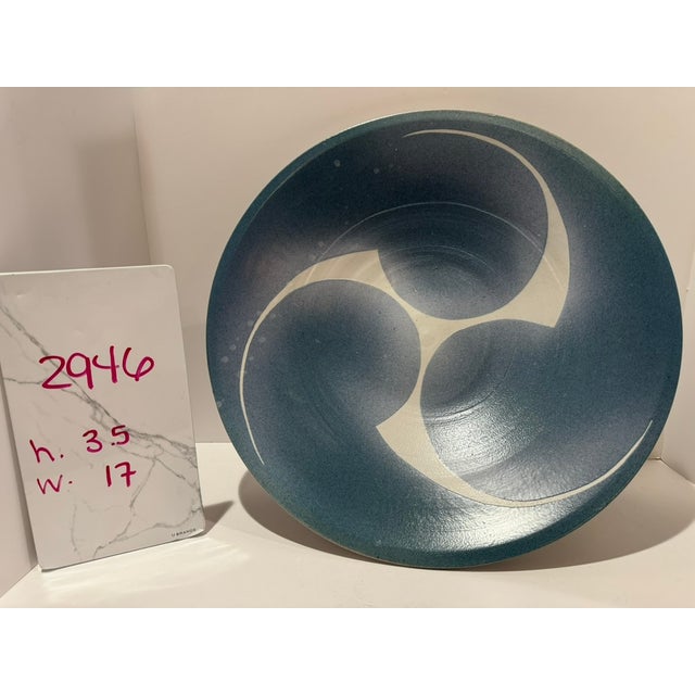 Large wheel-thrown studio pottery bowl, signed "Hughes" on the base, c. 1980s. A bold three-part swirl in the cream clay...