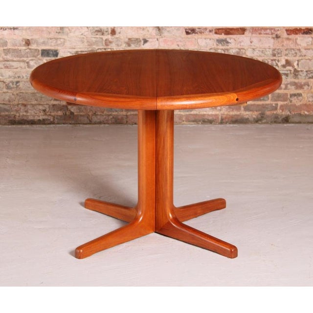 Danish Mid Century extending teak dining table, circa 1970s. The table comes with 2 extension leaves, extends to 208cm to...