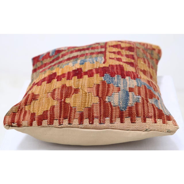 A one-of-a-kind handwoven Afghan wool kilim lumbar pillow featuring tribal geometric bands. Cut and sewn by hand from a...