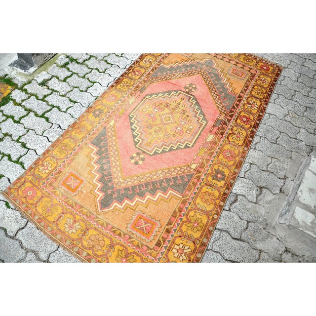 This is a vintage Turkish Oushak rug from the 1960s. The piece was hand-knotted.