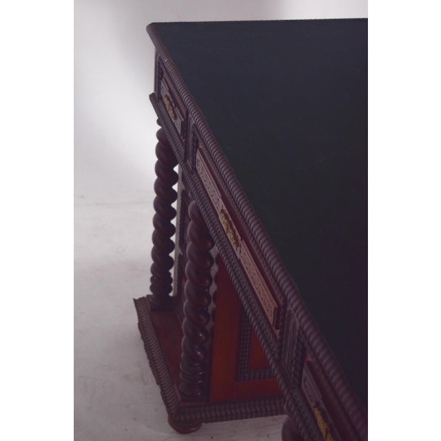 Twisted and shaken desk, 18th century, in rosewood. with spiral-turned columns that frame the side drawers, giving the...