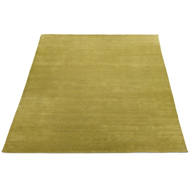 Discover our stunning handcrafted Gabbeh-style wool rug, showcasing a rich Antique Gold design. Proudly part of our Desert...
