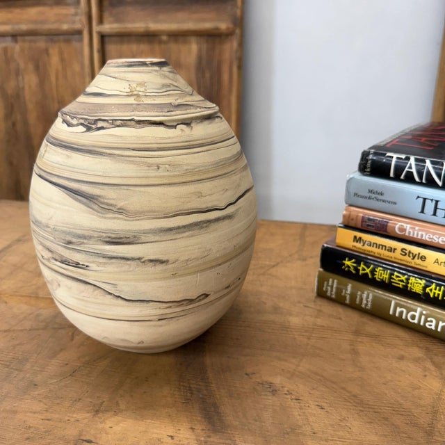 "About This Piece About This Piece Softly marbled and endlessly calming, this vase draws inspiration from wind-shaped...
