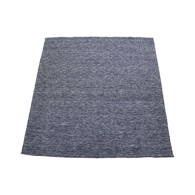 This beautiful modern hand-knotted wool rug has a navy blue color field and a gorgeous texture Strié design. This piece is...
