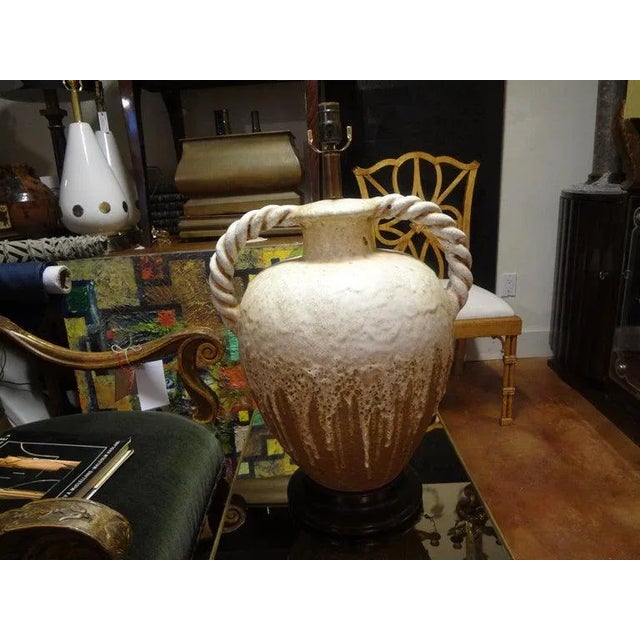 Gorgeous large midcentury Italian drip glaze pottery lamp with twisted handles. This Hollywood Regency lamp, attributed to...
