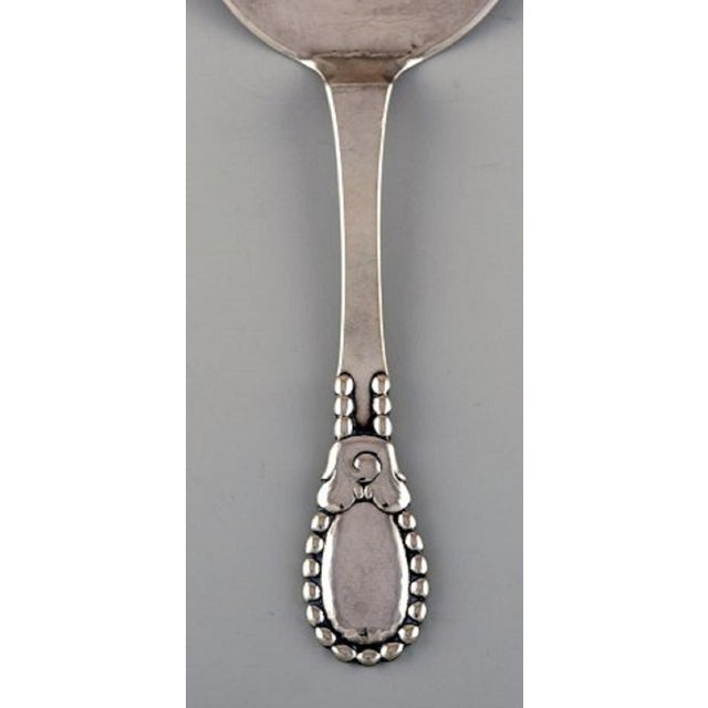 Evald Nielsen number 13 serving spade in hammered all silver 830. Dated 1922. Length: 16.5 cm. Stamped. In excellent...