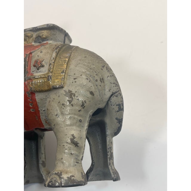 Charming and whimsical vintage cast iron elephant bank. Chippy paint. In really good condition for its age. Known as a...