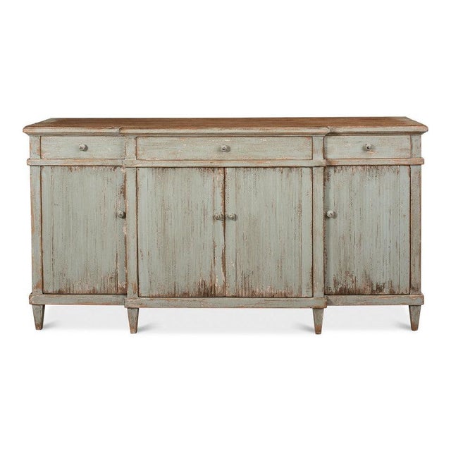 Soft gray-green paint sits below a natural wood top, following the country-furniture practice of leaving working surfaces...