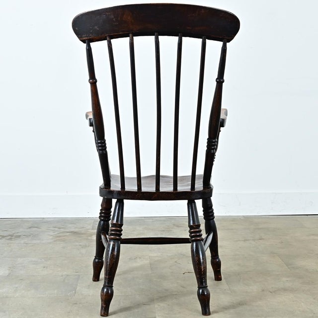 A handsome mid-19th century English Windsor chair built from solid elm and ash. This attractive chair has a high back with...