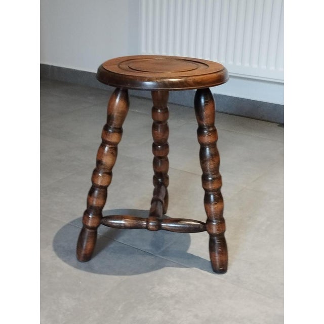 Mid-century tripod stool. Circa 1950. In the style of Charles Dudouyt. Round seat. Tripod base. Feet with beautiful...