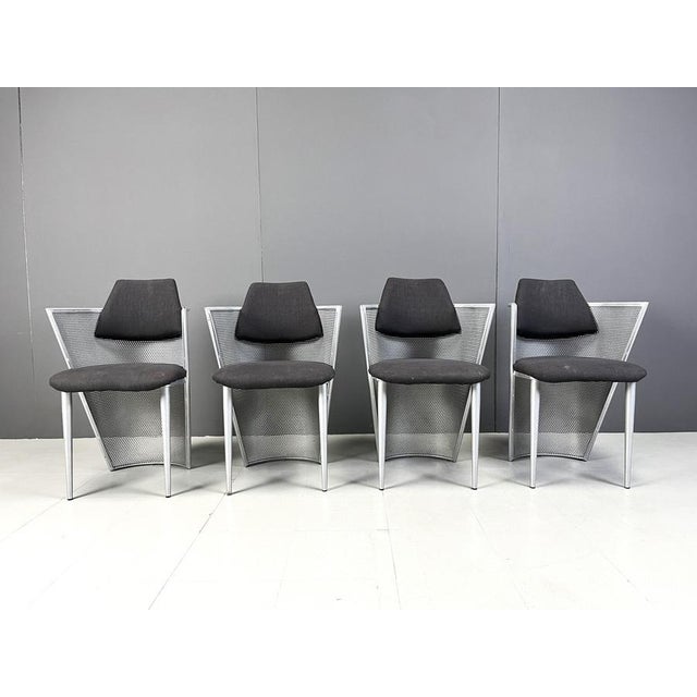 Set of 4 postmodern design armchairs/dining chairs made from a metal perforated frames and black fabric seats and...