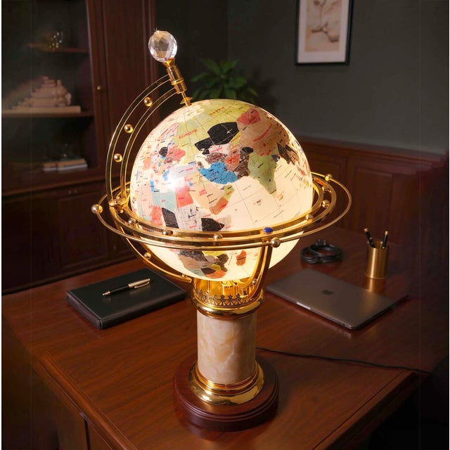 Illuminated world globe on a heavy marble column Sits on a stepped brass and mahogany wood base Accented with ornate brass...