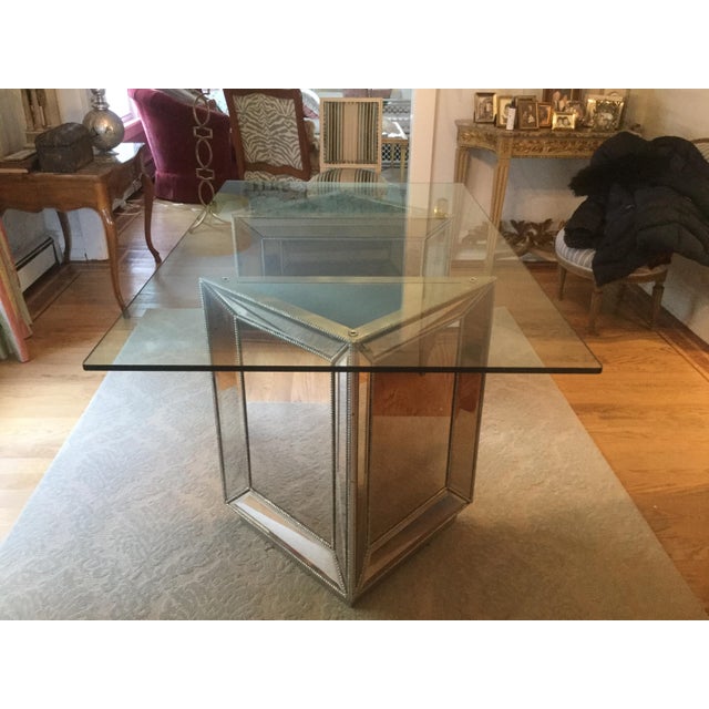 This is one very chic, high-end table. The base features 2 triangular pedestals with mirrors and beading on all 3 sides....