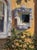 Garden Shadows by Sheri Farabaugh | Oil Painting of a mirror surrounded by greenery and wall. For Sale