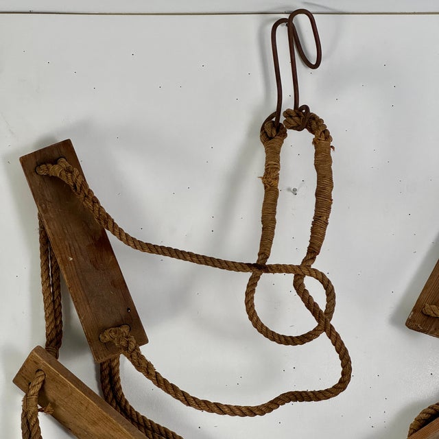 A unique primitive nautical step ladder constructed with rope, wood steps, and metal hook on top. Great for large wall...