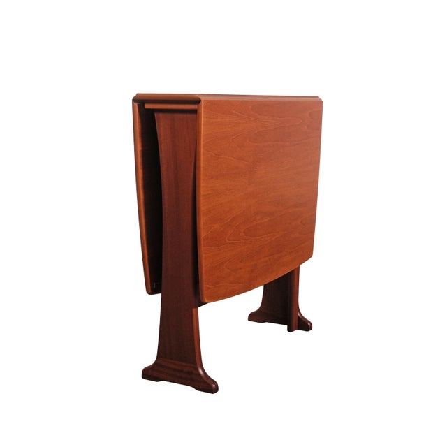 This exceptional Mid-Century Modern Teak Drop-Leaf Dining Table, designed in the distinguished G-Plan "Fresco" style, is a...