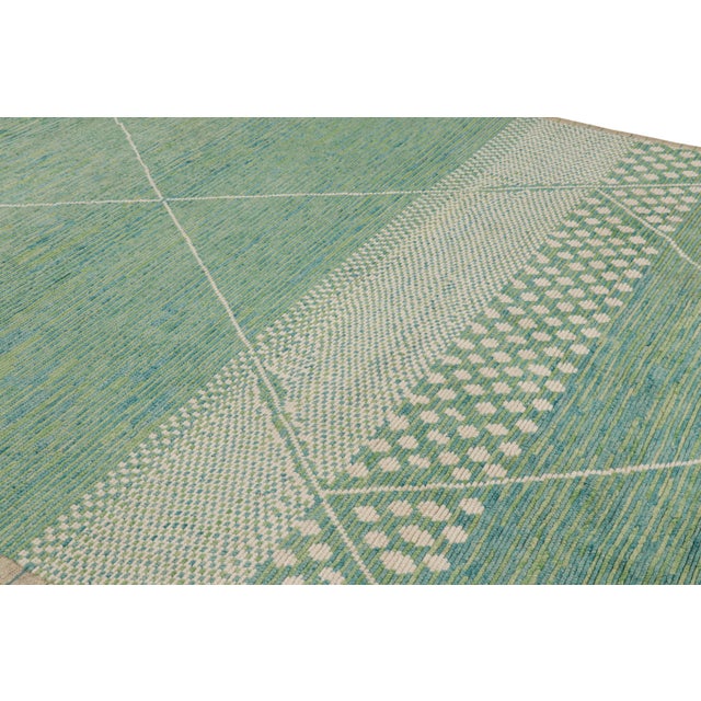 Made with hand-knotted wool, this 8x10 contemporary rug from Rug & Kilim features geometric patterns inspired by vintage...