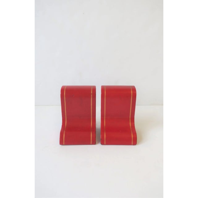 A beautiful set of red leather and gold embossed bookends, circa Mid-20th century, Italy. Each measure: 5.75" H