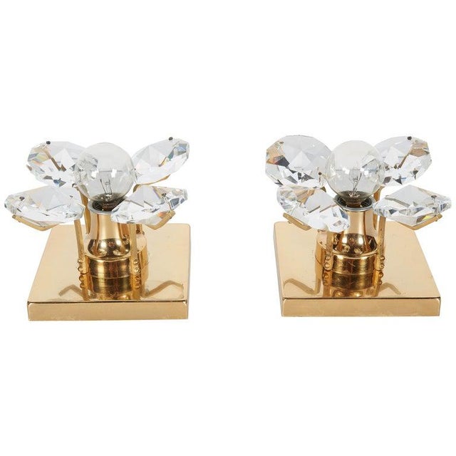 Pair of Mid-Century Modern sconces with four large cut crystals, creating a floral form. Each sconce is fitted with one...