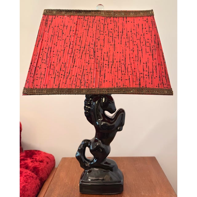 A striking and dramatic piece of classic Americana, this vintage 1950s ceramic table lamp features a beautifully sculpted...