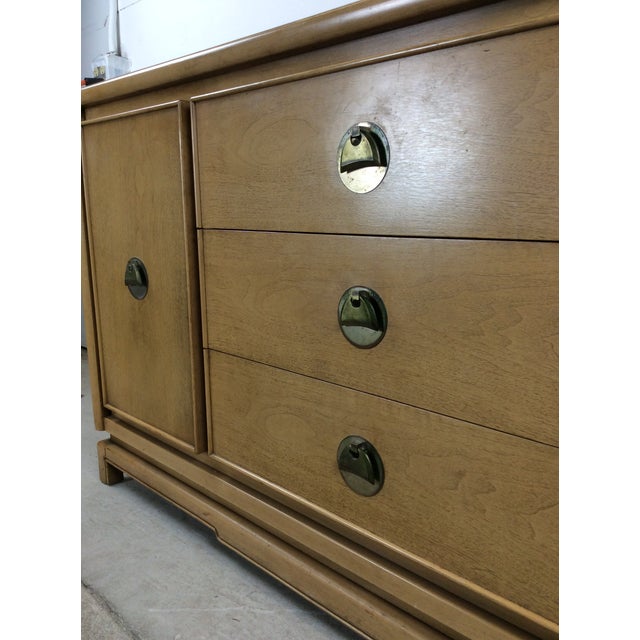 This mid century modern credenza features hardwood construction, original limed finish, three dovetailed drawers with...