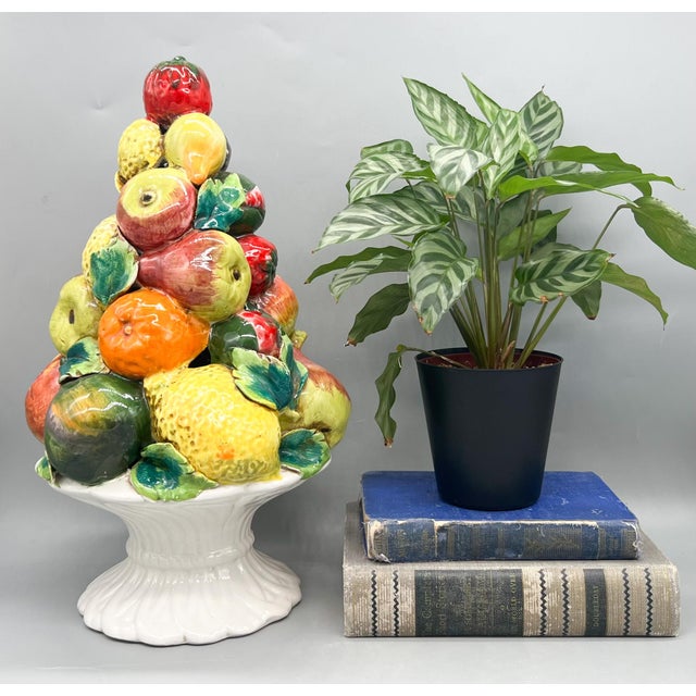 Striking, vintage ceramic fruit topiary centerpiece, featuring a richly detailed arrangement of apples, pears, citrus, and...