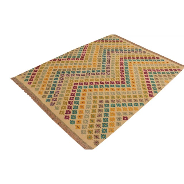 "Add a touch of elegance to your home with this casual chic hand woven Tribal Kilim wool rug. Constructed on a loom by...