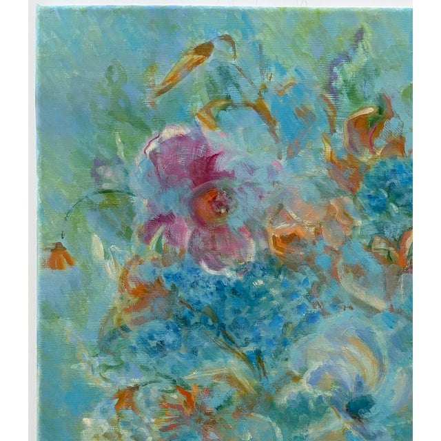 Ethereal floral bouquet that plays with the background blue. The multi-colored flowers become blurred floral forms hidden...