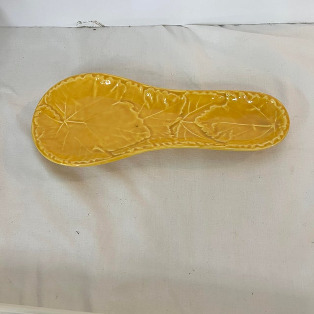 Olfaire leaf print spoon rest in color saffron . Generous enough for larger spoons. Measures 4” w x 9” long.