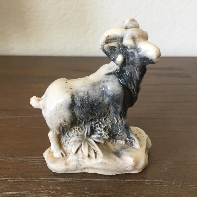 A finely carved bighorn sheep on mountain rock sculpture from natural Zebra Jasper, with beautiful variations in the...