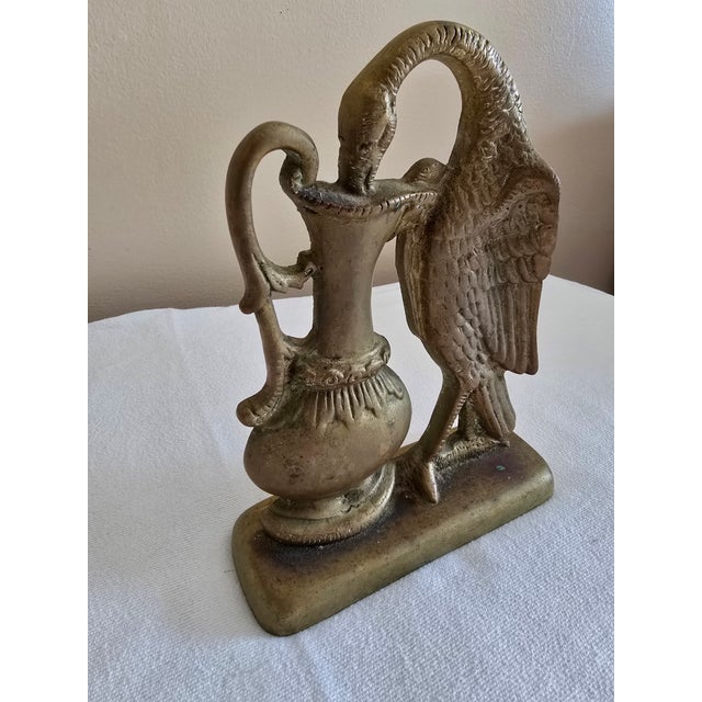 This rare 19th-century Ho-Ho bird doorstop is crafted from solid brass, showcasing exceptional antique craftsmanship....