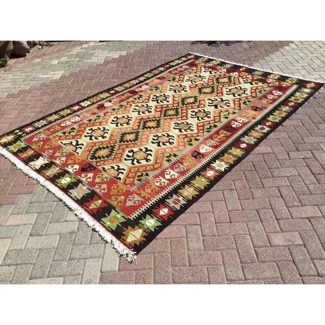 This beautiful, vintage, handwoven kilim is approximately 60 years old. It is handmade, of very fine quality wool and in...