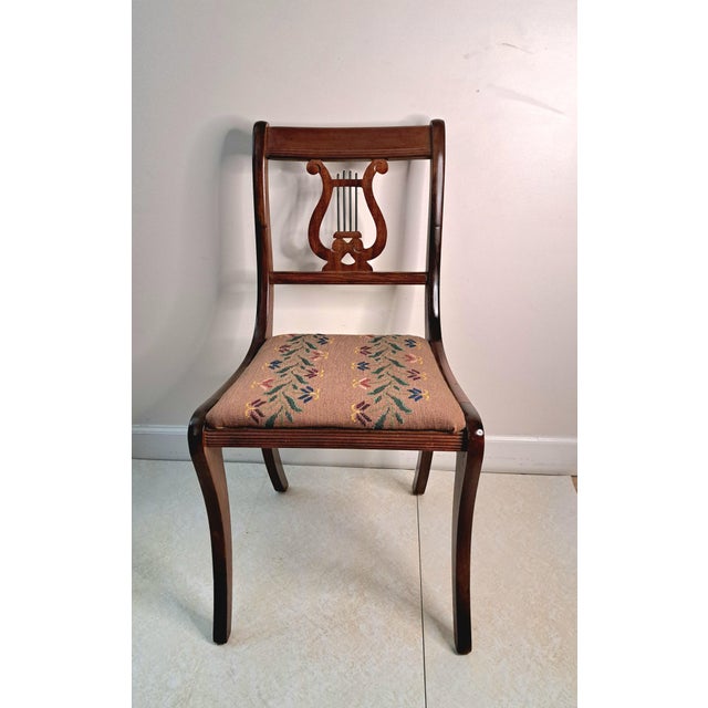 A handsome early 20th-century Duncan Phyfe-style mahogany lyre-back side chair, circa 1920s–1940s. This Colonial Revival...