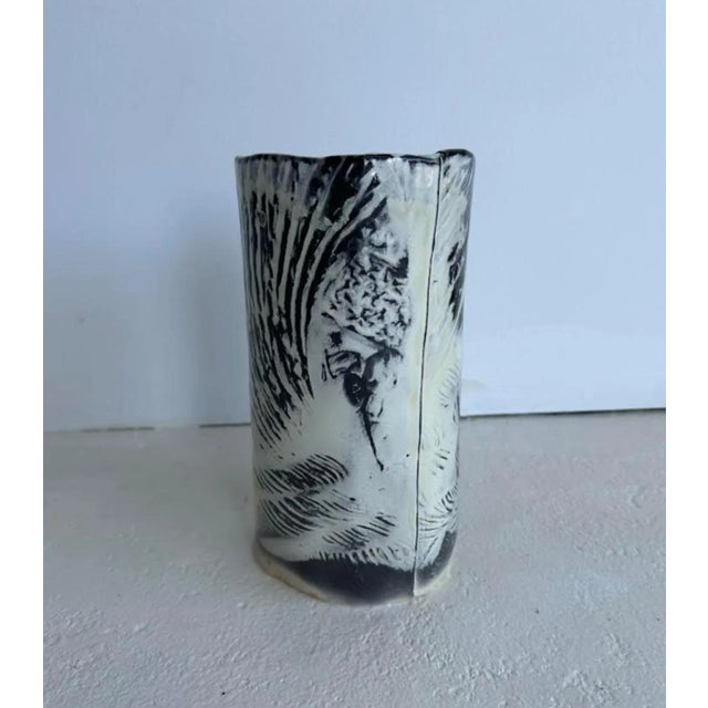 A soda fired porcelain vase that features a shell and rope motif in a striking black and white finish. It’s a nice piece...